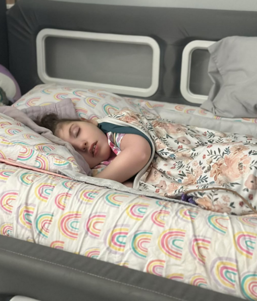 A young child sleeping in a SleepSafe bed.