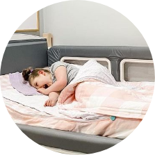 Kaiya lying in her SleepSafe bed.