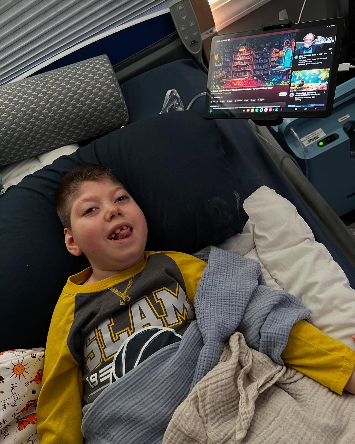 A young boy lying in a SleepSafe bed