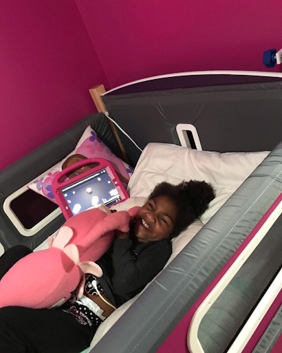 A young girl lying in her SleepSafe bed.