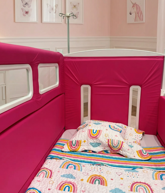 A SleepSafe bed with an IV pole behind it.